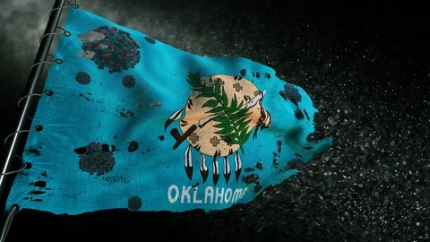 The flag of Oklahoma is torn and marked with the virus of covid-19 . 動画素材 127198938