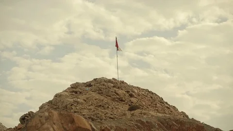 The flag of Oman flies in the wind on top of a mountain Stock Footage 119240466