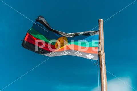 Photograph: Flag of the original Mapuche people in blue sky. #165371837