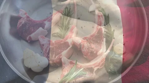 Flag overlay drifting across, casting color bands over dish with lamb chops, Stock-Footage 329533358