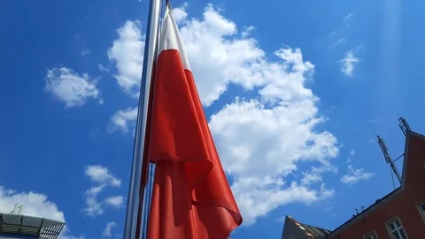 Flag of Poland flutters on blue sky with clouds background. Stock Footage 254124773