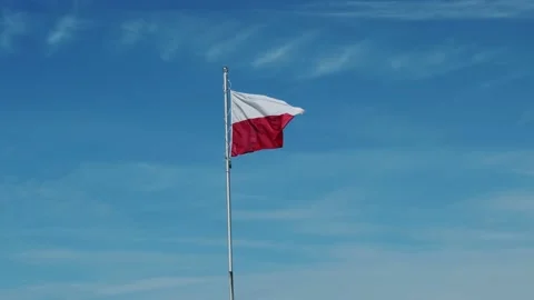 The flag of Poland flutters in the wind. blue sky . white and red flag of Poland Stock Footage 208945697