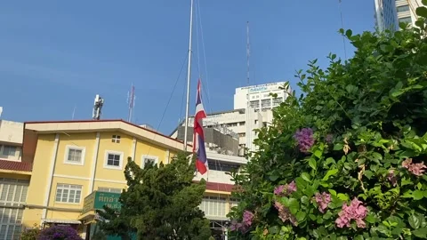 Flag raising ceremony at 8 A.M. at Ratchawithi hospital in the sunny morning Stock Footage 265081554