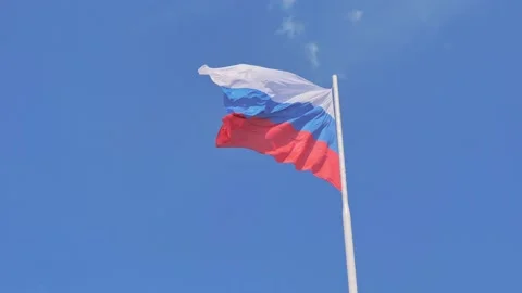 The flag of the Russian Federation hangs on a flagpole and flutters in the wind Stock Footage 235454153