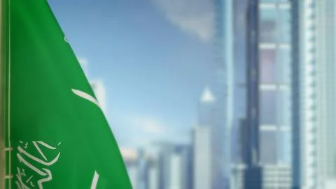Flag of Saudi Arabia on modern city buildings bokeh backdrop for day Ilustración de archivo