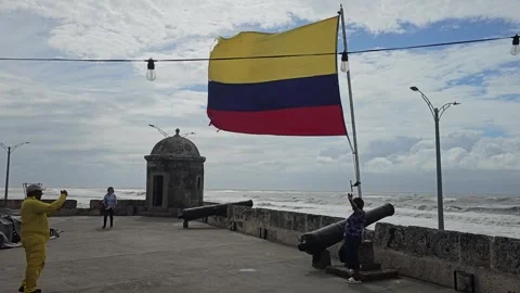 Flag, Sentry Box and Cannon on Windy Seafront Wall, Cartagena, Colombia 8K Stock Footage 331503440