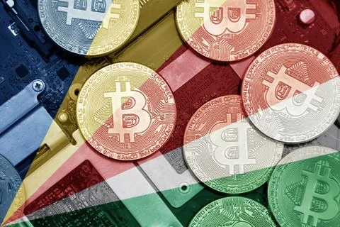 Flag of seychelles on the bitcoins with computer electronic circuit board b.. Stock Photos