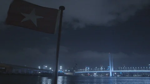 Flag on Ship at Night City View Stock Footage 123389534