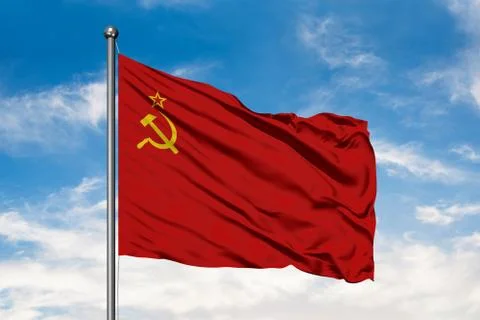Flag of Soviet Union waving in the wind against white cloudy blue sky. USSR F Stock-Fotos
