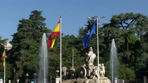 Flag of Spain and NATO waving together around the Plaza de Cibeles in Madrid Stock Footage 199224430