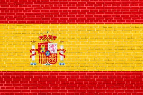Flag of Spain on brick wall texture background Stock Photos