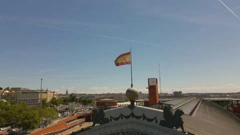 Flag of Spain is flailing in the wind on top of a bus station in Valencia, 4k Stock Footage 164856584