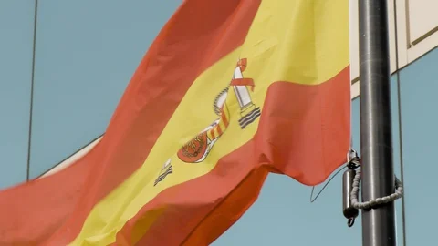 Flag of Spain floating in the wind next to glass building 스톡 동영상 123884300