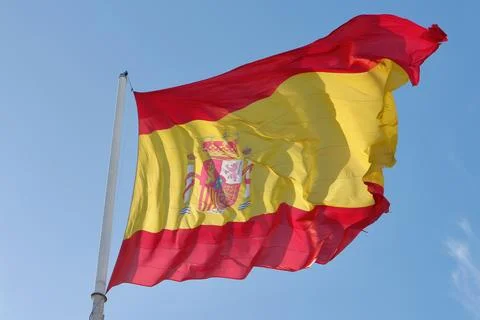 Flag of Spain moved by the strong wind outside. Spanish national symbolics Stock Photos