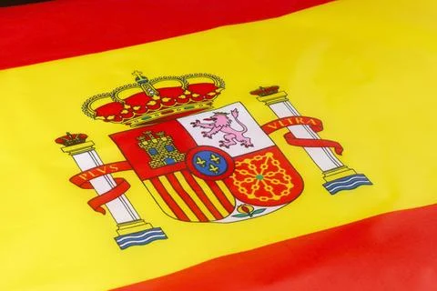 Flag of Spain waving gently, showcasing vibrant colors and royal emblem Stock Photos