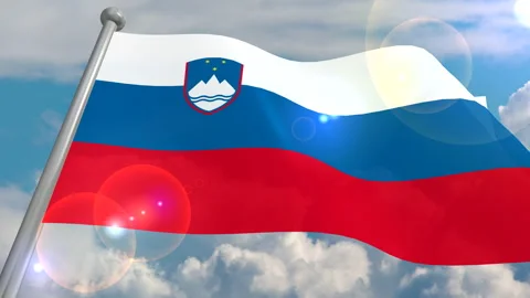 The flag of the state of Slovenia is developing in the wind against a blue sky Stock Footage 134574709