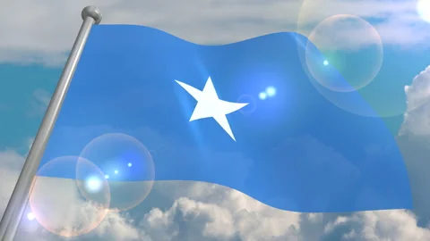 The flag of the state of Somalia develops in the wind against a blue sky Video stock 134574931
