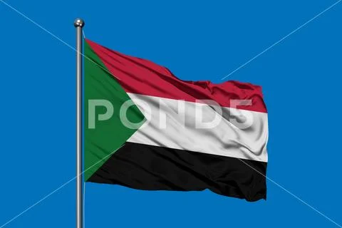 Flag of Sudan waving in the wind against deep blue sky. Sudanese flag ...