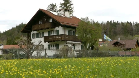 Flag swaying on the wind next to the house Stock Footage 75437198