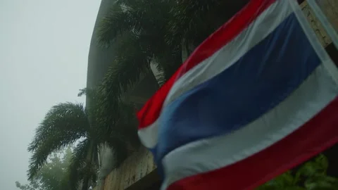 The flag of Thailand develops in the center of the Big Buddha | Thailand Stock Footage 223301964