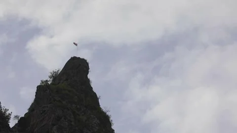 Flag on top of a cliff Stock Footage 245706321