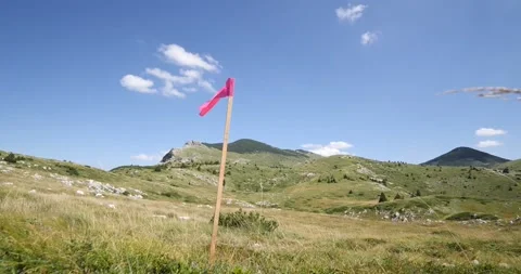 Flag for trail running race. Flag in the mountain for keeping runners on the tra Stock Footage 139986649
