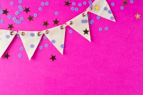 Flag triangular decorativ, party garland over colorful pink background. Chris Stock-Fotos
