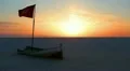 Flag of Tunisia in broken boat during the beautiful sunrise in desert HD Footage