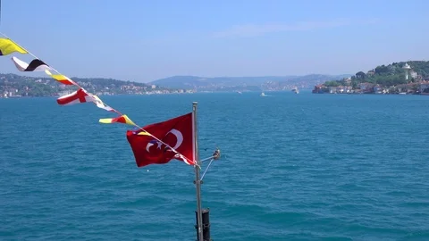 Flag of Turkey against the background of emerald water of the Bosphorus Stock Footage 112733275