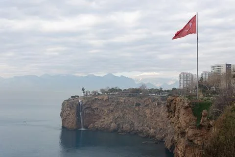 Flag of Turkey on a cliff by the sea in cloudy weather Stock Photos