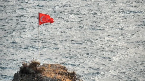 Flag of Turkey on a flagpole stands on a rock in slow motion. Stock Footage 129200269