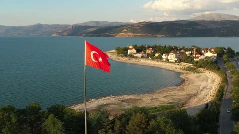 The flag of Turkey is fluttering in the wind among the beautiful landscape of Stock Footage 221043776