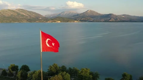 The flag of Turkey is fluttering in the wind among the beautiful landscape of Stock Footage 221044651
