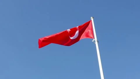 Flag of Turkey waving in wind against blue sky. Slow motion video. Video stock 259498653