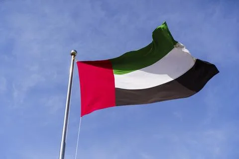 Flag of the UAE on background of the sky in Dubai. Arab Emirates, Persian Gulf. Stock Photos