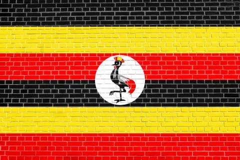 Flag of Uganda on brick wall texture background Stock Photos