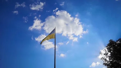 Flag of Ukraine against the backdrop of a bright sky and shimmer of the sun. Ukr Stock Footage 252346708