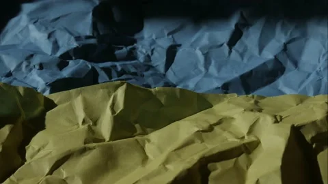 The flag of Ukraine appears from the darkness. Video stock 171176751