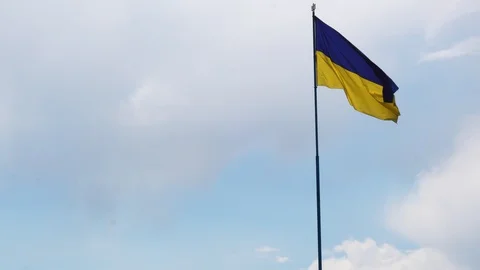 Flag of Ukraine on the background of blue sky Stock Footage 129792899