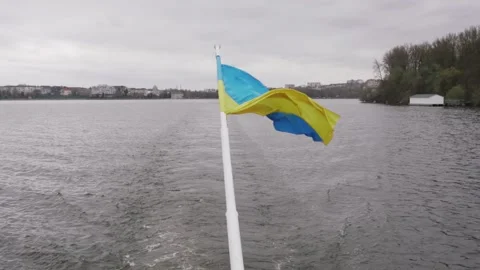 The flag of Ukraine on the background of a large lake Stock Footage 260305576