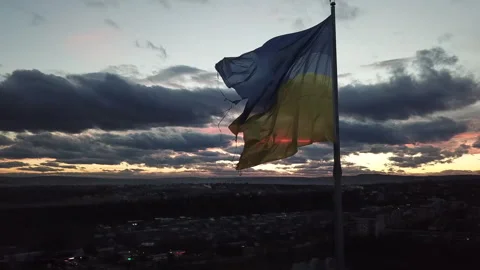 The flag of Ukraine on the background of the sunset. Torn flag. Dramatic scene 스톡 동영상 268323246