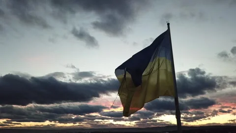The flag of Ukraine on the background of the sunset. Torn flag. Dramatic scene 스톡 동영상 268323482