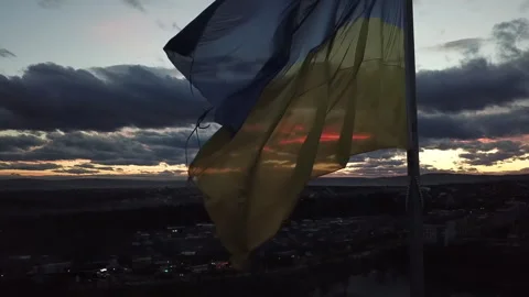 The flag of Ukraine on the background of the sunset. Torn flag. Dramatic scene Video stock 268323500