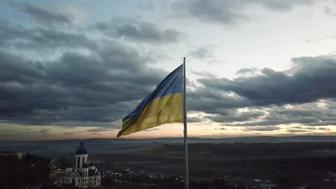 The flag of Ukraine on the background of the sunset. Torn flag Video stock 268323750