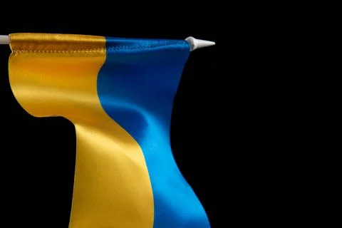 Flag of Ukraine on dark background is developing in the wind. Yellow and blue Photos