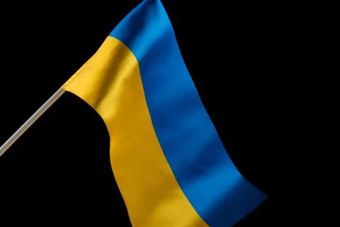 Flag of Ukraine on dark background is developing in the wind. Yellow and blue Photos
