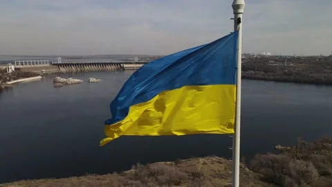 The flag of ukraine is developing in the wind, a view of the dam, the Dnieper Stock Footage 151459565