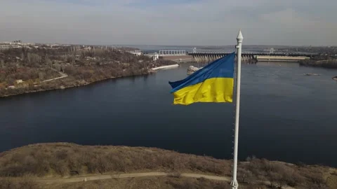 The flag of ukraine is developing in the wind, a view of the dam, the Dnieper Stock Footage 151459661