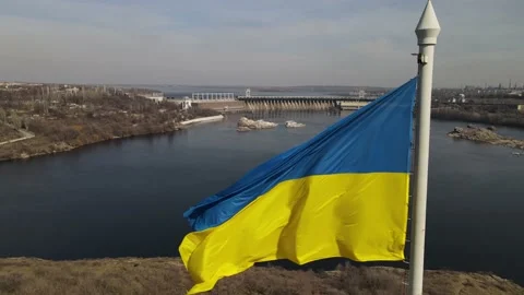 The flag of ukraine is developing in the wind, a view of the dam, the Dnieper Stock Footage 151459690