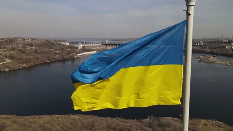The flag of ukraine is developing in the wind, a view of the dam, the Dnieper Stock Footage 151459828
